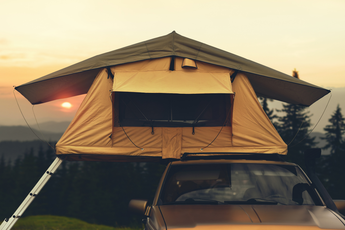 Rooftop tent with sun setting in background