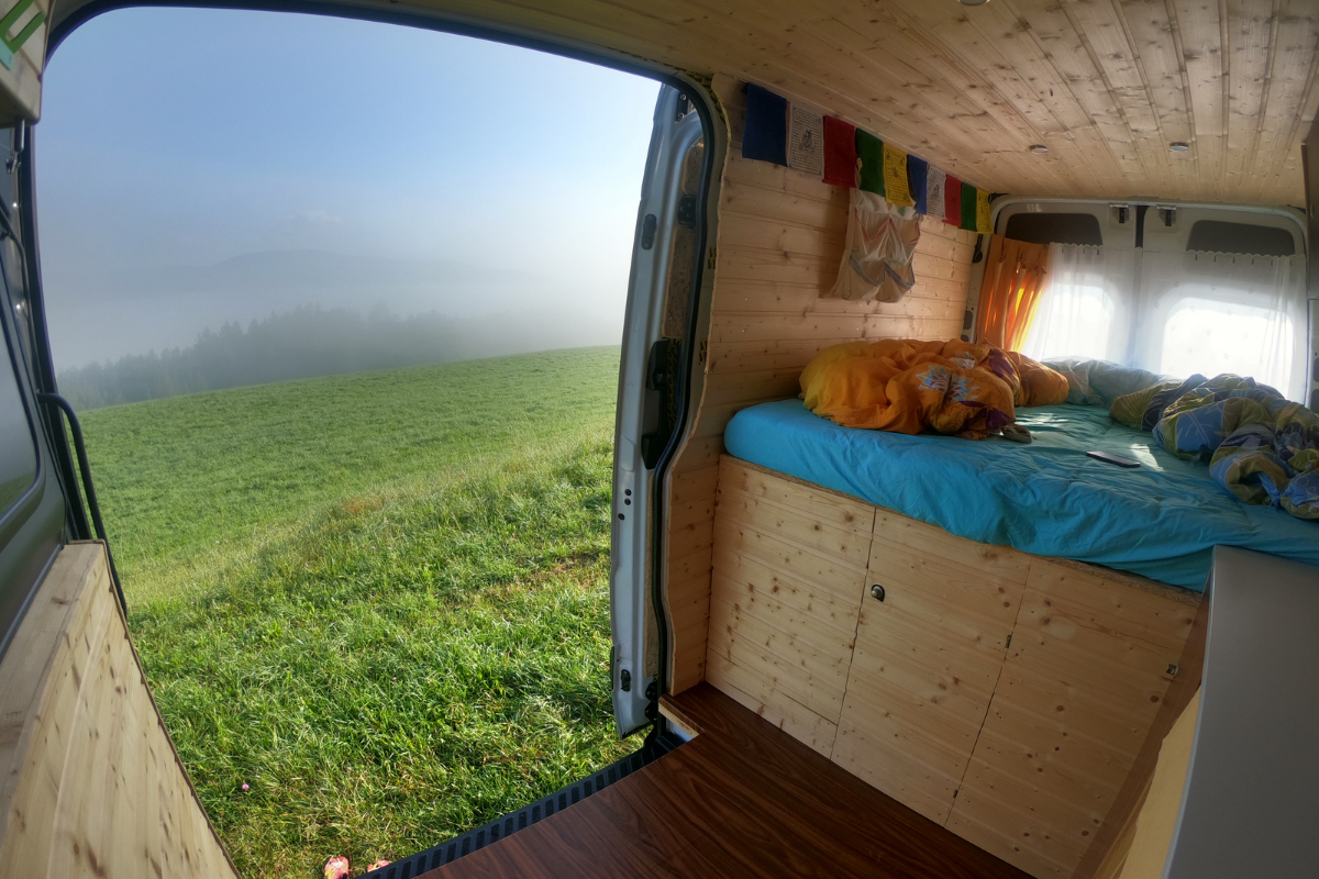 A beautiful Camping bus is parked on a green field on a sunny day